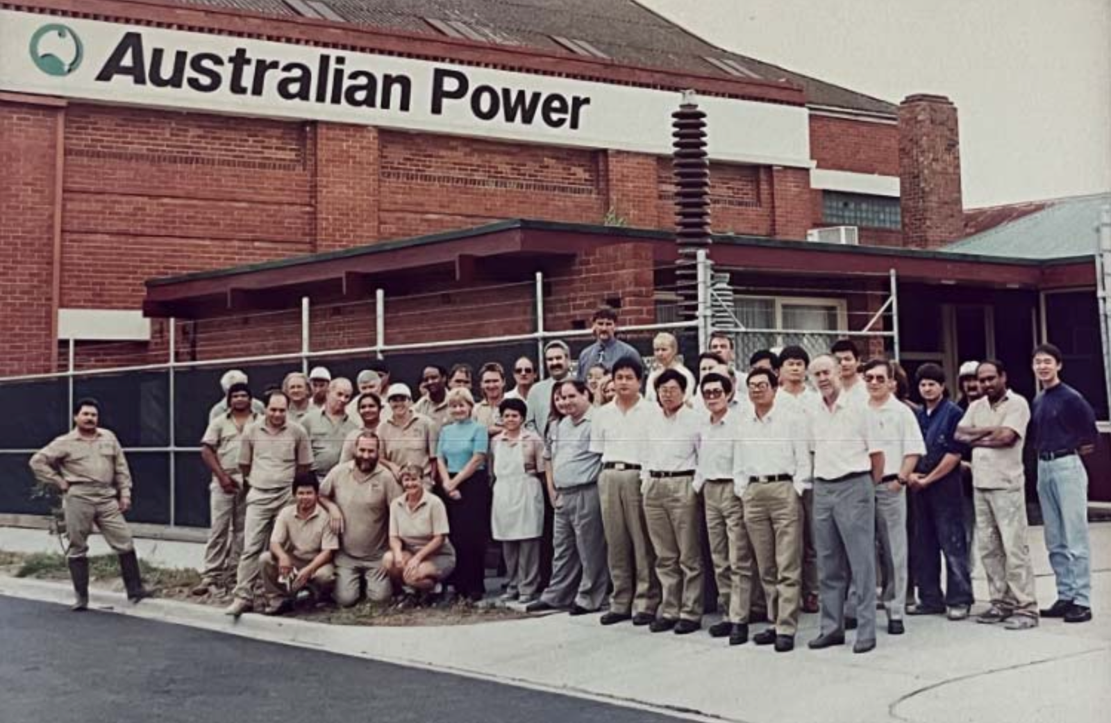 Historical Vuulcan insulator project team at Australian Power facility with high voltage porcelain post insulator