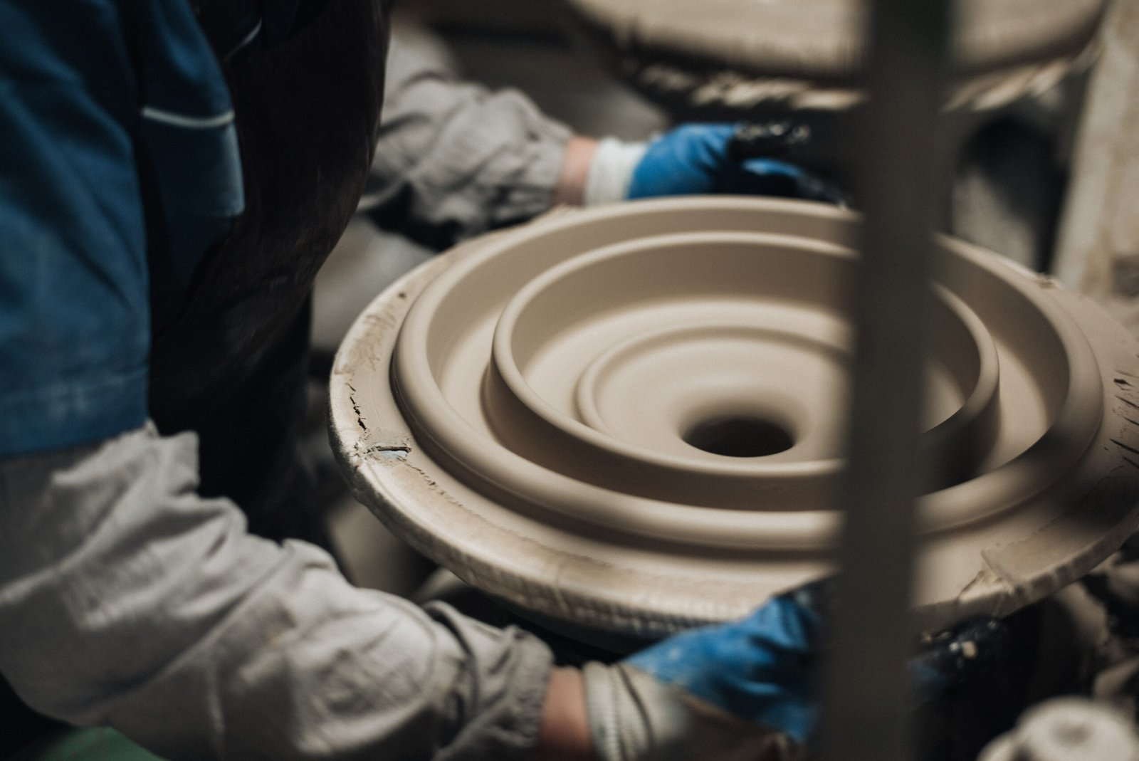 Craftsman hand finishing porcelain insulator clay body